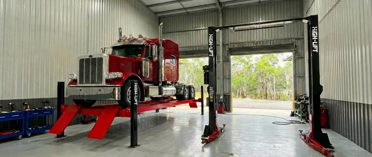 Red truck on heavy duty workshop hoist