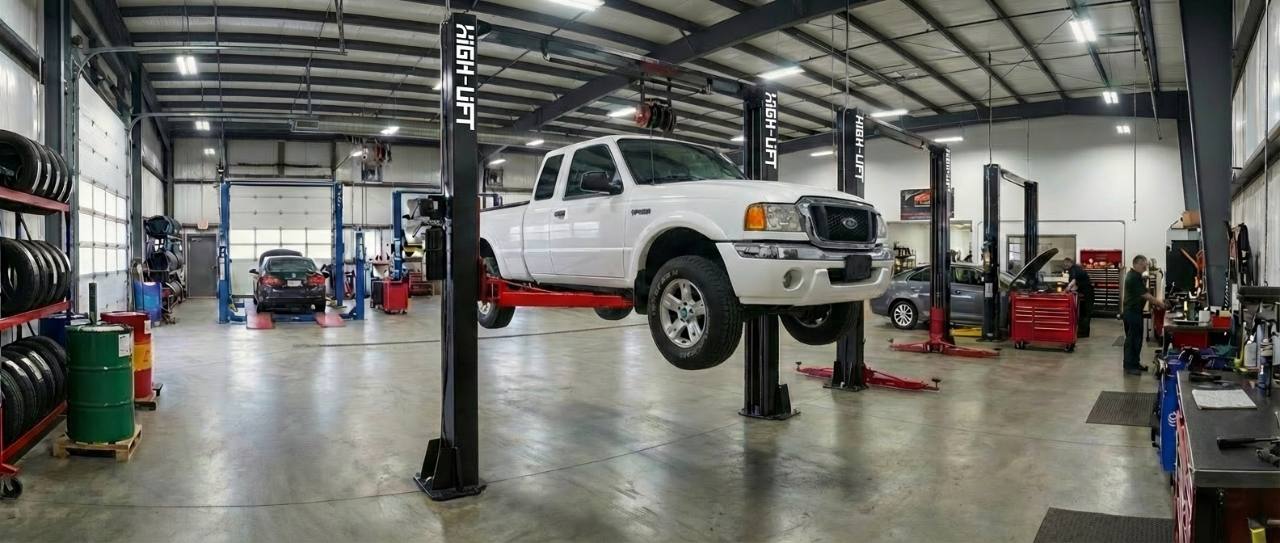 White ute lifted on workshop hoist